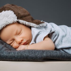 portrait of adorable sleeping newborn baby in hat
